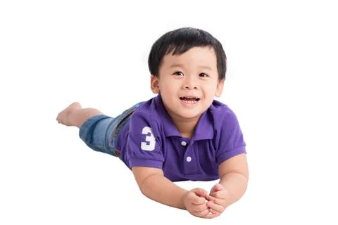 Cute asian boy lying down on white background isolated Stock Photos