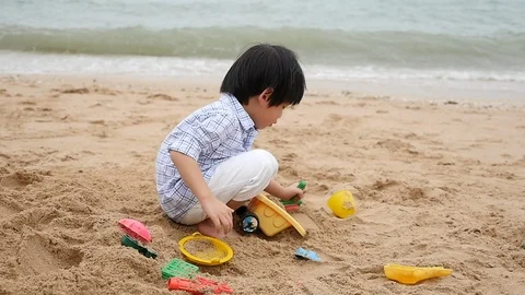 Cute asian child playing on the beach slow motion Stock Footage 86042016
