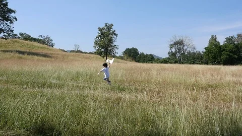 Cute Asian child playing pilot aviator in the field outdoors slow motion Stock Footage 85924657