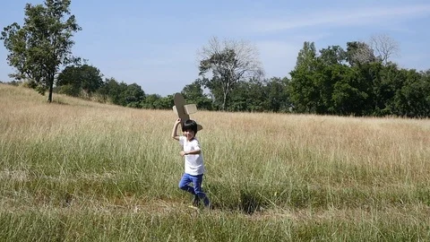 Cute Asian child playing pilot aviator in the field outdoors slow motion Stock Footage 85925329