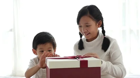 Cute Asian children opening gift present box Stock Footage 70407635