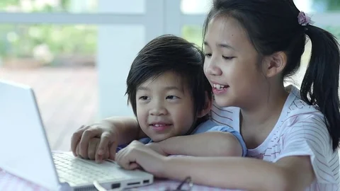 Cute Asian children using tablet together slow motion Stock Footage 79095375