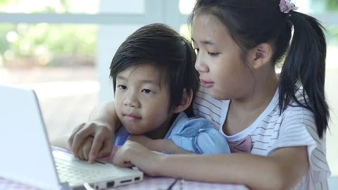 Cute Asian children using tablet together slow motion Stock Footage 79095501