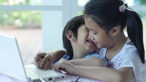 Cute Asian children using tablet together slow motion Stock Footage 79095568
