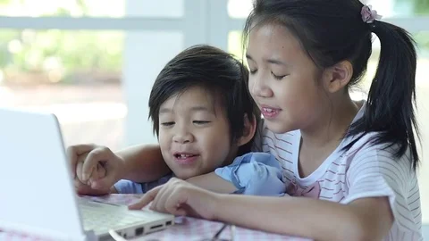 Cute Asian children using tablet together slow motion Stock Footage 79193775