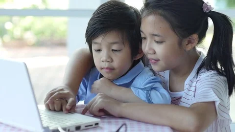 Cute Asian children using tablet together slow motion Stock Footage 79194592