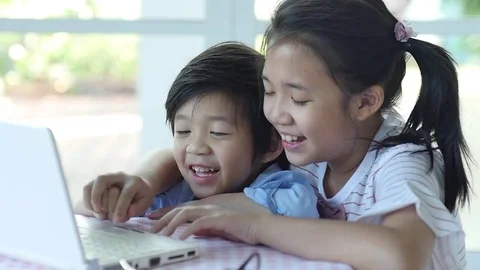 Cute Asian children using tablet together slow motion Stock Footage 79196173