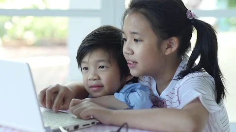 Cute Asian children using tablet together slow motion Stock Footage 79196292