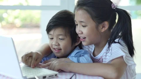 Cute Asian children using tablet together slow motion Stock Footage