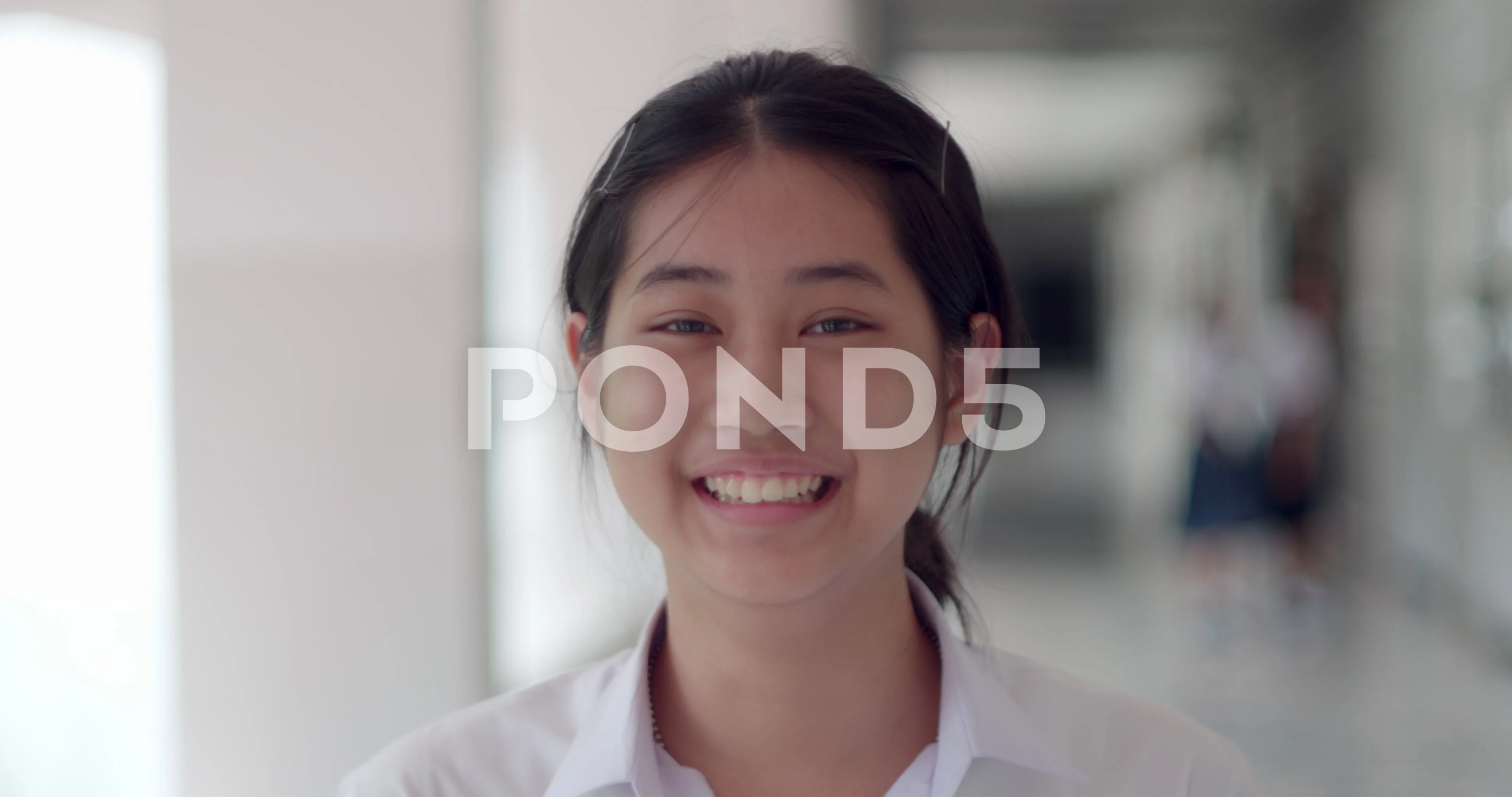 A cute Asian female student teen girl in white uniform Laugh and laugh