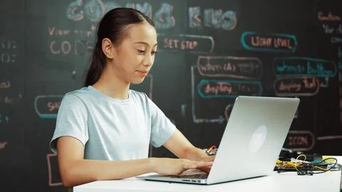 Cute asian girl programing system by using laptop at blackboard. Edification. 스톡 사진
