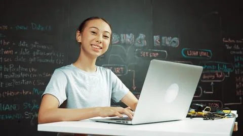 Cute asian girl programing system by using laptop at blackboard. Edification. 스톡 사진