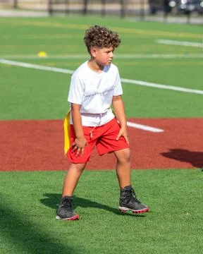 Cute athletic boy playing flag football Stock Photos