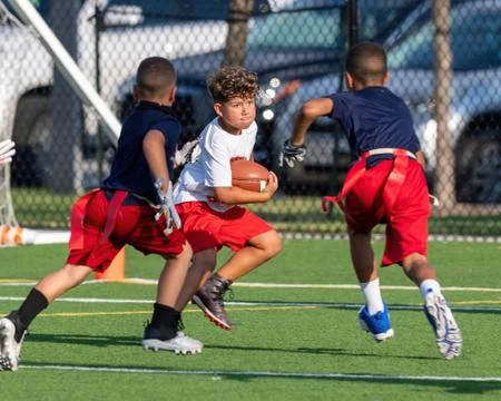 Cute athletic boy playing flag football Stock Photos