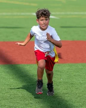 Cute athletic boy playing flag football Stock Photos