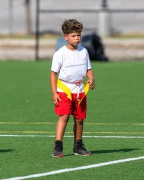 Cute athletic boy playing flag football Stock Photos