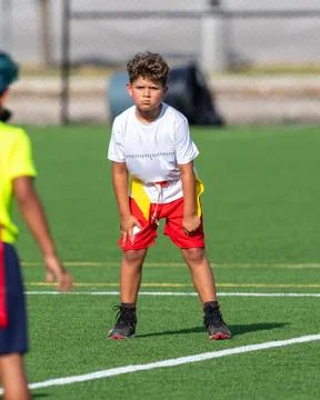 Cute athletic boy playing flag football Stock Photos