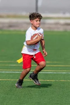 Cute athletic boy playing flag football Stock Photos
