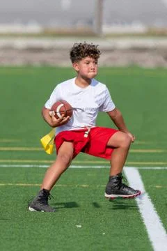 Cute athletic boy playing flag football Stock Photos