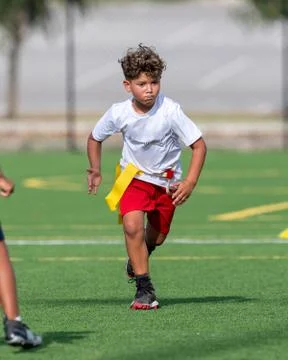 Cute athletic boy playing flag football Stock Photos