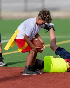 Cute athletic boy playing flag football Stock Photos