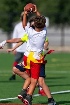 Cute athletic boy playing flag football Stock Photos
