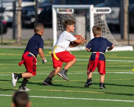 Cute athletic boy playing flag football Stock Photos