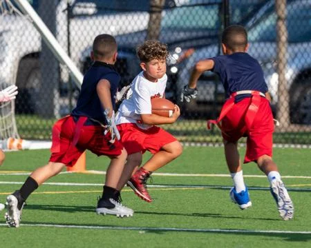 Cute athletic boy playing flag football Stock Photos