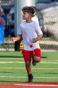 Cute athletic boy playing flag football Stock Photos