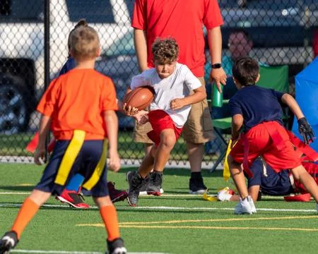 Cute athletic boy playing flag football Stock Photos