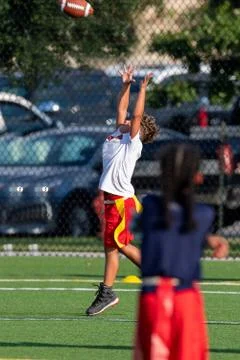 Cute athletic boy playing flag football Stock Photos