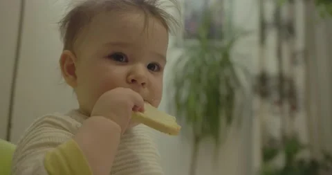 Cute babe pointing with bread before bite curiously Stock Footage 229618745