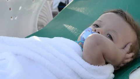 Cute babe sunbathing on the beach lying on a  near the sea Vídeos de archivo 96773716