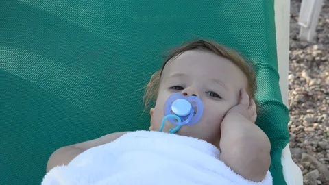 Cute babe sunbathing on the beach lying on a  near the sea 動画素材 96773867