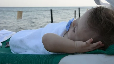 Cute babe sunbathing on the beach lying on a  near the sea 스톡 동영상 96774543