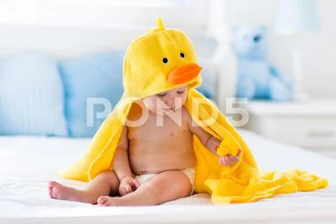 Cute baby after bath in yellow duck towel Stock Photos
