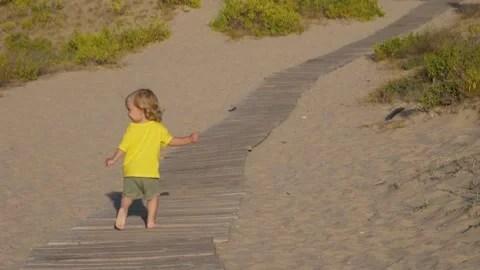 Cute baby on a beach path Stock Footage 311672573