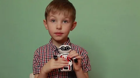 Cute baby boy with an interactive toy robot, a beautiful close-up portrait. Stock Footage 125183532