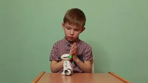 Cute baby boy playing with an interactive toy robot. Stock Footage 125183515