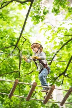 Cute baby boy playing. Kid climbing trees in park. Hike and kids concept Stock Photos