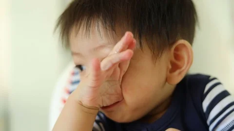 Cute baby boy using finger hand in mouth itchy gum, slow motion scene Stock Footage 81252704
