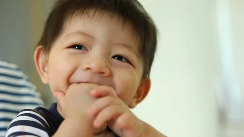 Cute baby boy using finger hand in mouth itchy gum, slow motion scene Video stock 82984997