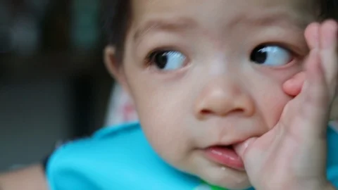 Cute baby boy using finger hand in mouth itchy gum of grow the milk teethe Stock Footage 88319927