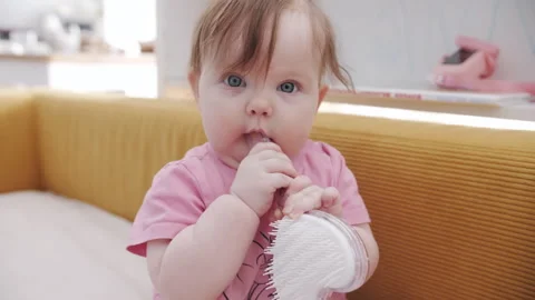 Cute Baby Child Exploring Object at Home with Curious Emotions Видео 336156731