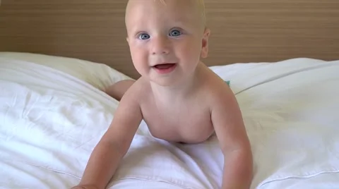 Cute baby crawling on bed Stock Footage 65134542