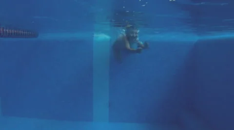 Cute  baby diving into a pool and swimming under water Stock Footage 53300760