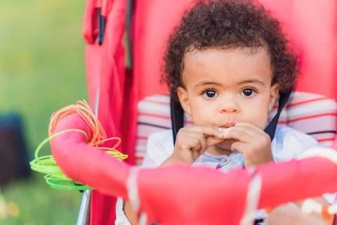 Cute baby eats a cookie Stock Photos