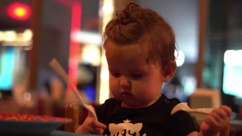 Cute Baby Girl Eating at the Restaurant. Close up Stock Footage