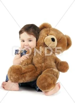 Cute baby girl hugging teddy bear Stock Photos