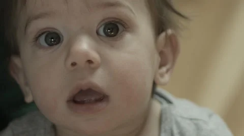 A cute baby looking into the camera, spacing out Stock Footage 63269404